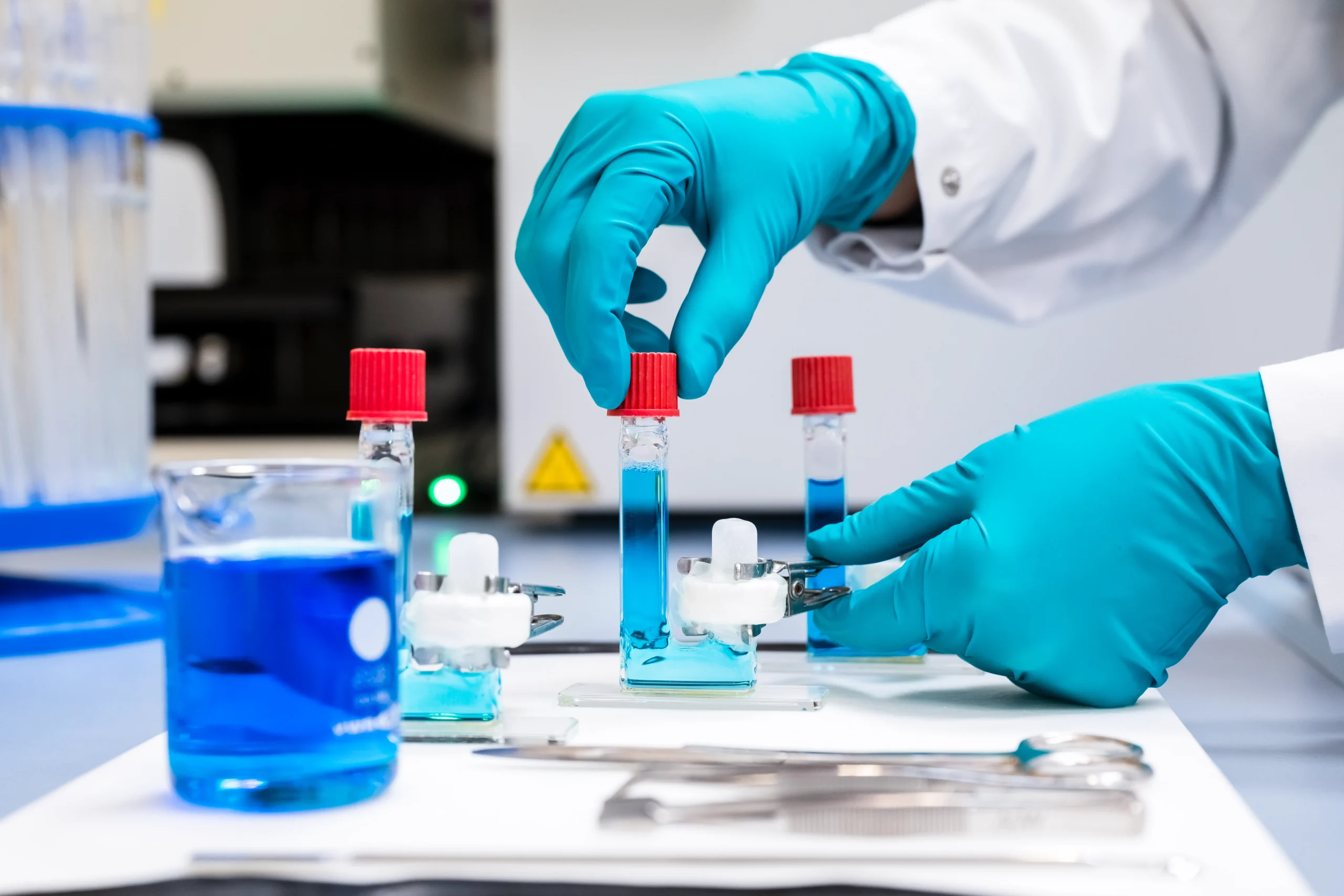 Manufacturing technician operating film coating and packaging line at AdhexPharma commercial production facility, Chenove